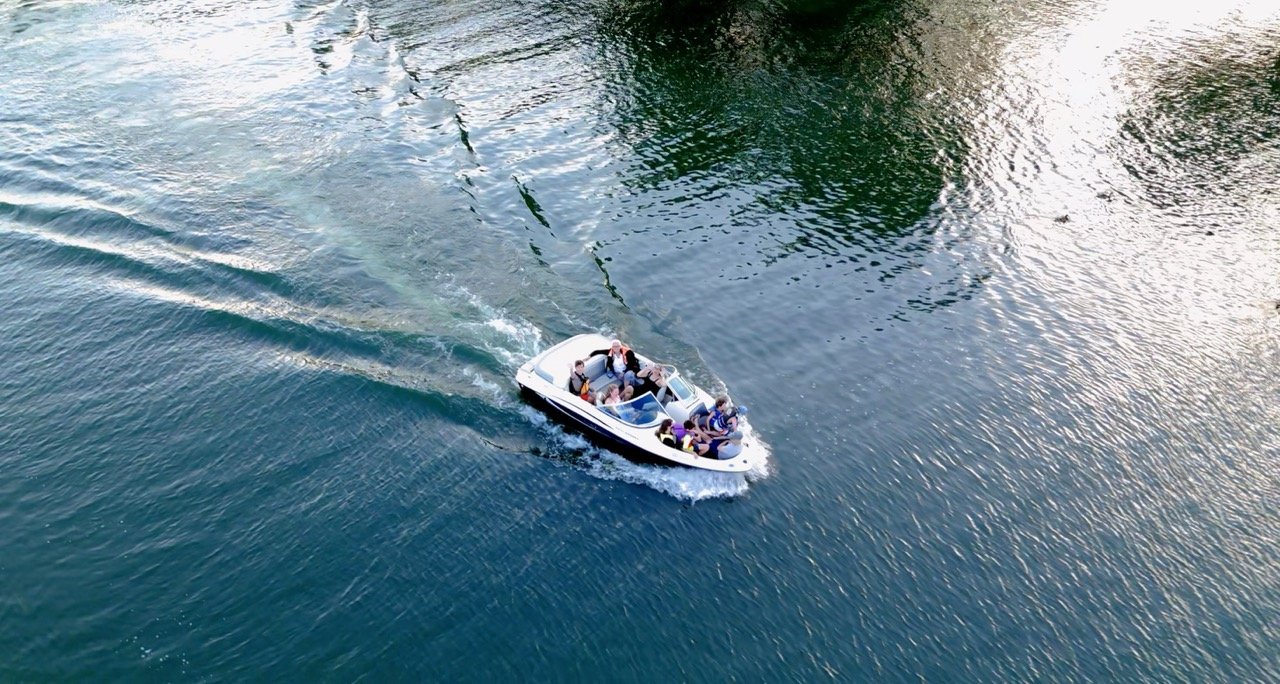 Aerial view of a motorboat creating a wake on the water