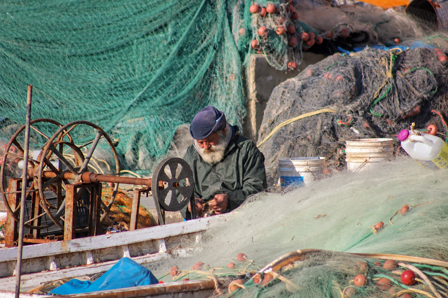 A fisherman at work among nets and winches