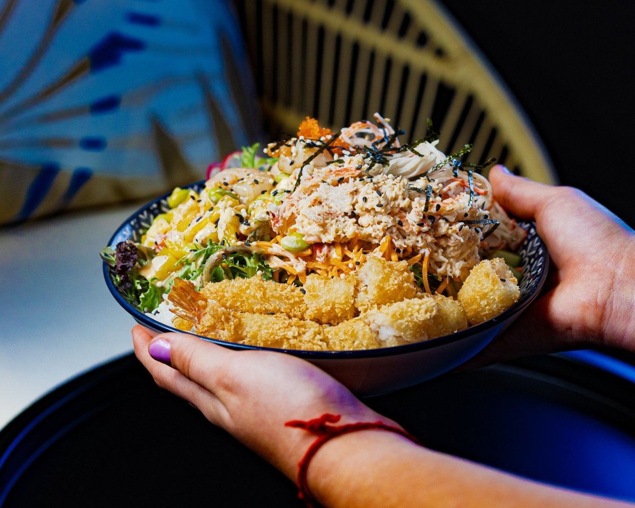 Close-up lifestyle shot of a person eating with chopsticks