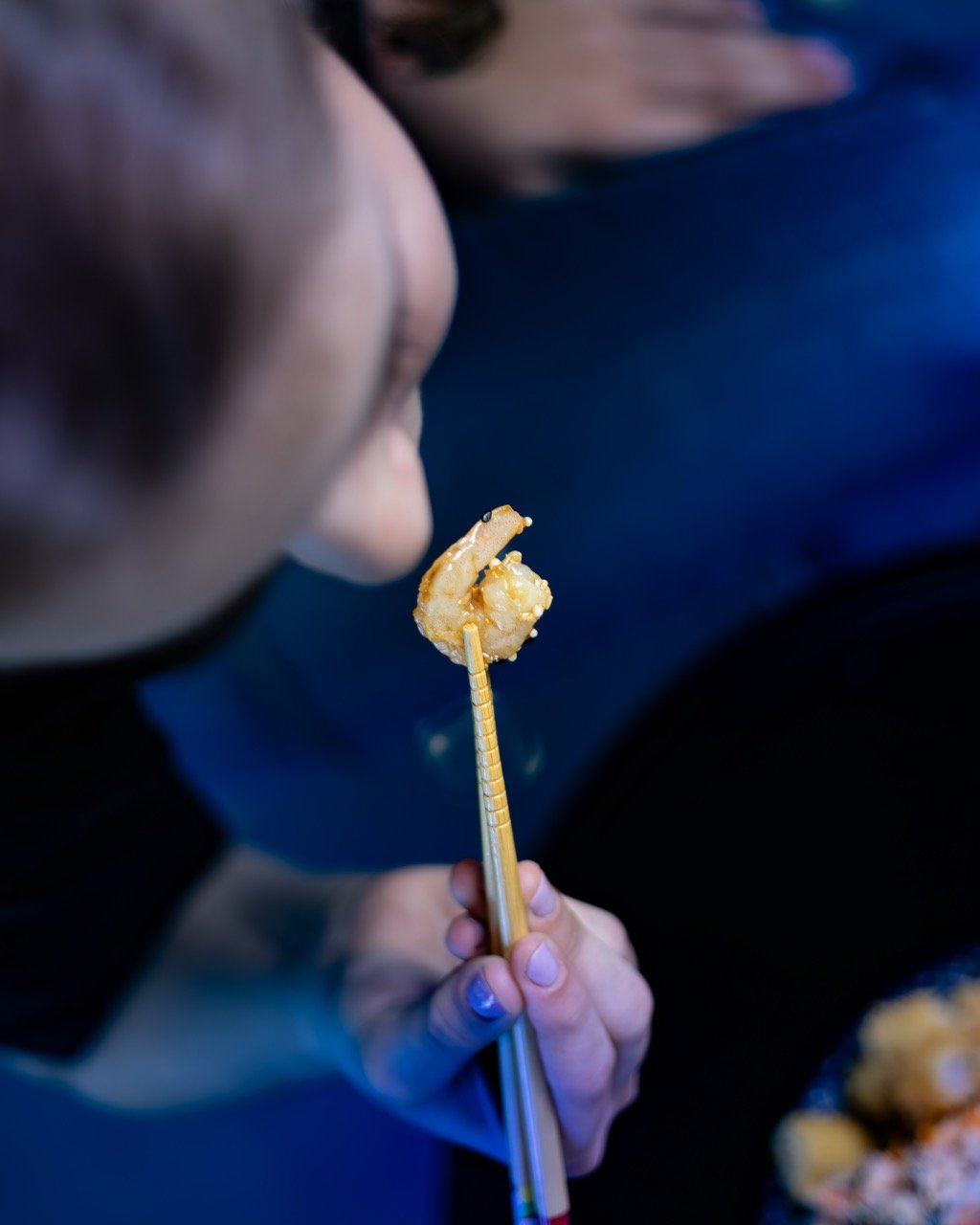 Hands presenting a beautifully prepared fusion bowl